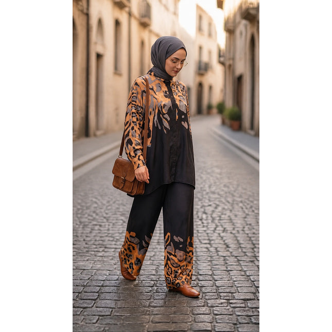 Brand Zee two-piece co-ord set with animal print shirt and wide-leg trousers in black, ochre, and grey on a woman.