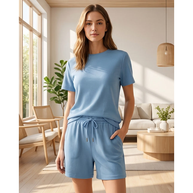 Brand Zee blue cotton loungewear set with a crew-neck t-shirt and drawstring shorts worn by a woman in a living room