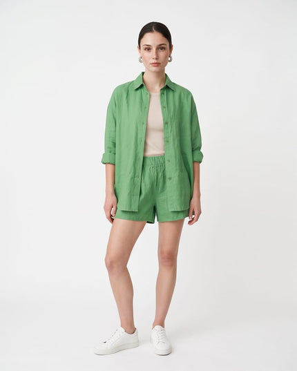 Model wearing a Brand Zee green relaxed linen-look shirt and shorts co-ord set made from modal and viscose blend