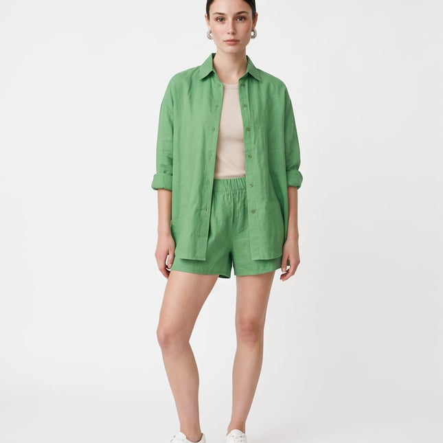 Model wearing a Brand Zee green relaxed linen-look shirt and shorts co-ord set made from modal and viscose blend