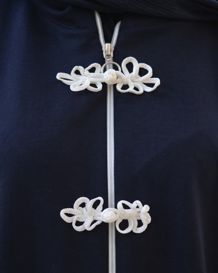 Brand Zee navy blue zip-up tracksuit top featuring white decorative knot fastenings and a high-neck collar