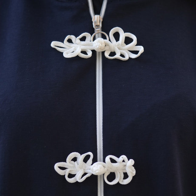 Brand Zee navy blue zip-up tracksuit top featuring white decorative knot fastenings and a high-neck collar