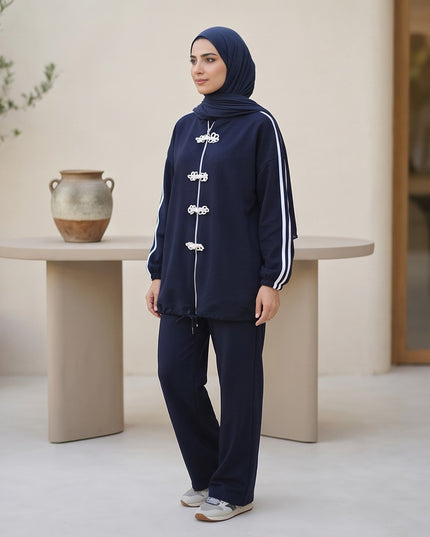 Brand Zee navy blue two-piece sporty lounge set with white knot fastenings and side stripes worn with a matching hijab