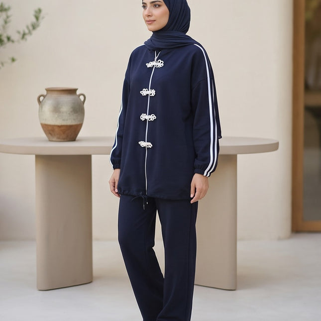 Brand Zee navy blue two-piece sporty lounge set with white knot fastenings and side stripes worn with a matching hijab