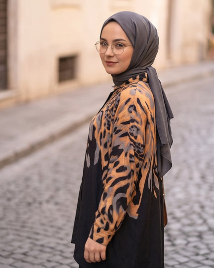 Brand Zee two-piece set featuring a long-sleeve shirt with a black and ochre animal print worn with a grey hijab.