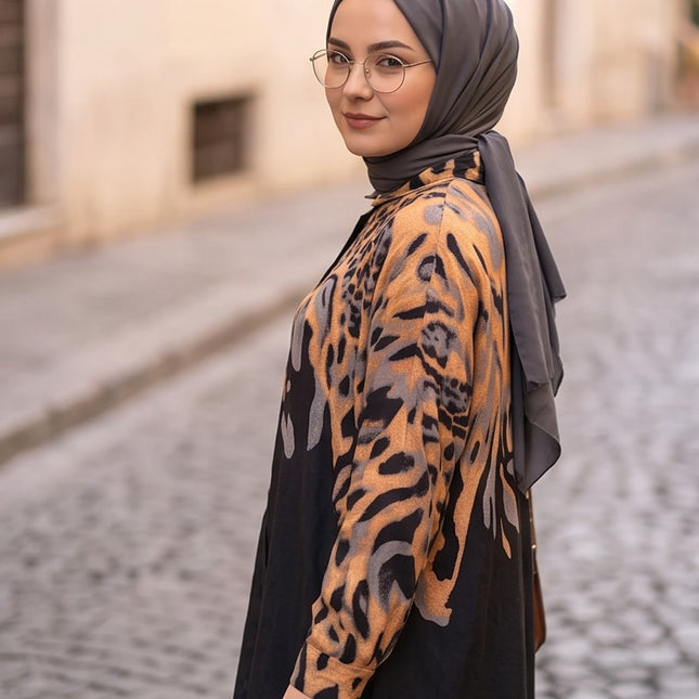 Brand Zee two-piece set featuring a long-sleeve shirt with a black and ochre animal print worn with a grey hijab.