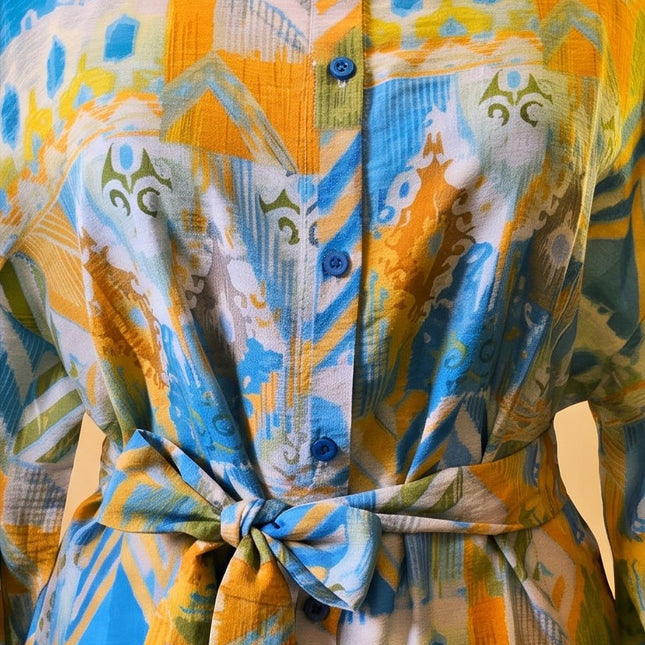 Brand Zee long sleeve shirt featuring a vibrant yellow, blue, and green abstract print with a tie-waist and buttons.