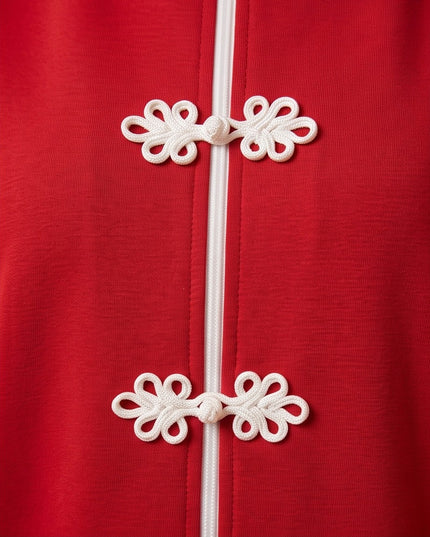 Brand Zee red zip-up tracksuit top featuring decorative white knot fastenings and a central white zip detail