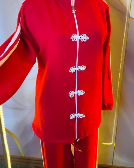 Brand Zee red two-piece sporty tracksuit with white side stripes and decorative knot fastenings on the zip-up top.