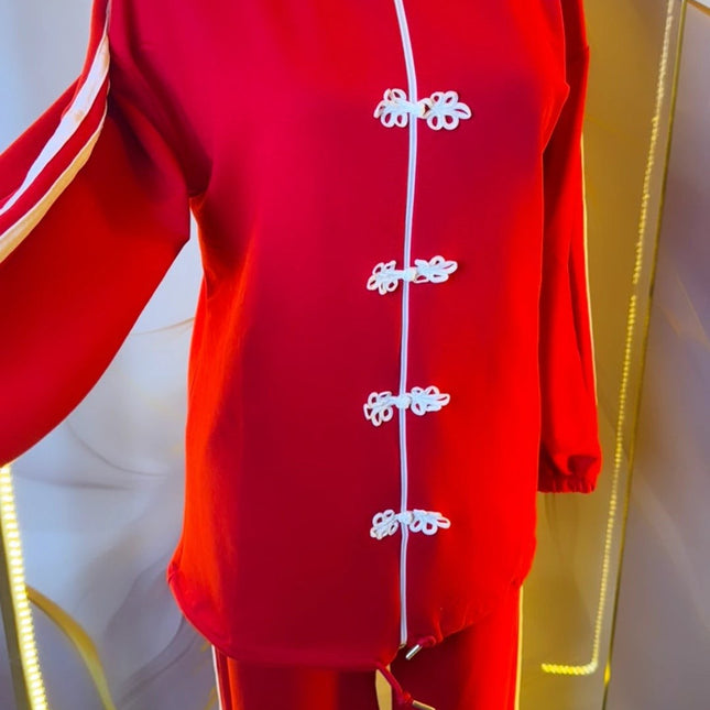 Brand Zee red two-piece sporty tracksuit with white side stripes and decorative knot fastenings on the zip-up top.