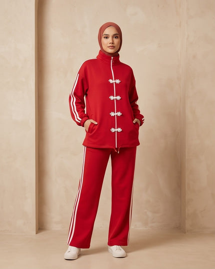 Brand Zee red two-piece sporty tracksuit with white side stripes and decorative knot fastenings on a zip-up top.