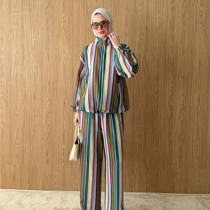 Model wearing a Brand Zee multicoloured striped zip-up jacket and matching wide-leg trousers made in Turkey.