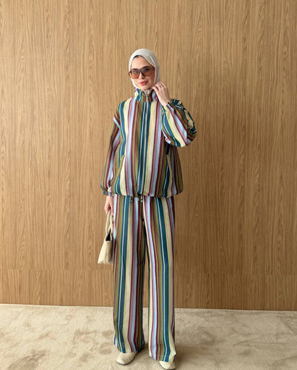 Model wearing a Brand Zee multicoloured striped zip-up jacket and matching wide-leg trousers made in Turkey.