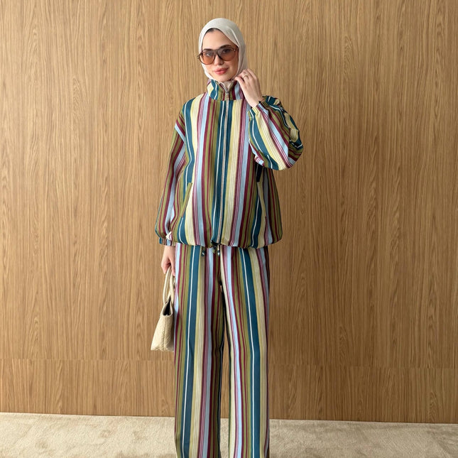 Model wearing a Brand Zee multicoloured striped zip-up jacket and matching wide-leg trousers made in Turkey.