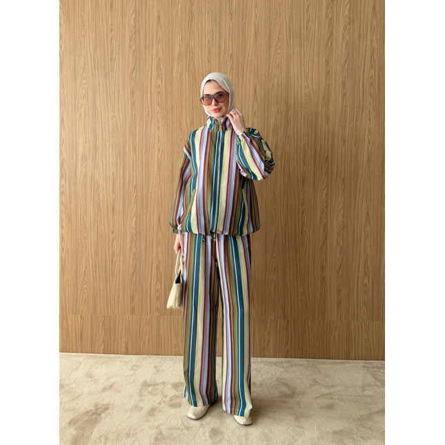 Model wearing a Brand Zee multicoloured striped zip-up jacket and matching wide-leg trousers made in Turkey.