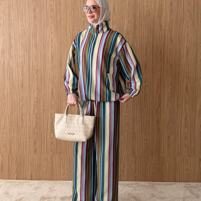 Brand Zee striped two-piece set with a zip-up top and wide-leg trousers, worn with a beige hijab and matching handbag.
